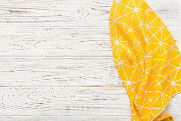top view with yellow empty kitchen napkin isolated on table background. Folded cloth for mockup...