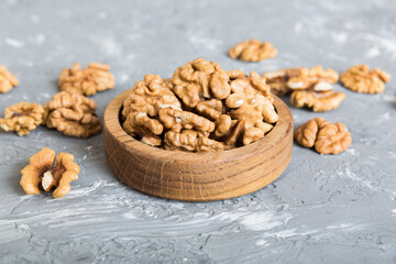 Fototapeta na wymiar Fresh healthy walnuts in bowl on colored table background. Top view Healthy eating bertholletia concept. Super foods