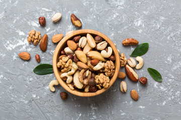 mixed nuts in bowl. Mix of various nuts on colored background. pistachios, cashews, walnuts, hazelnuts, peanuts and brazil nuts