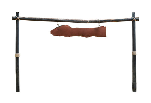 Empty aged wooden shingle or hanging signboard in the countryside with poles and beam, dark brown color, isolated image on white background.