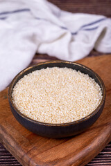 Sesame seeds. Organic White Sesame seeds (Sesamum indicum) on wooden background. Close up