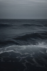 Fototapeta premium A closeup shot captures the dark sea's wave hitting the black sand of an Iceland beach,.Contrast against the white foam. Stormy day. Bad weather, cloudy sky. Atmospheric moody day. Generative AI.