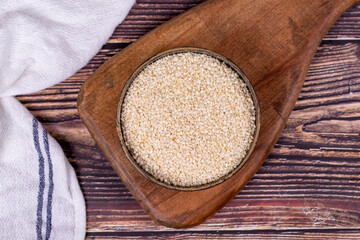 Sesame seeds. Organic White Sesame seeds (Sesamum indicum) on wooden background. Top view