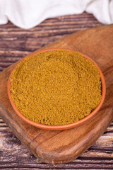 Ground cumin or Jeera Powder. Powder cumin spice in bowl on wooden background. Dry spice concept. Close up