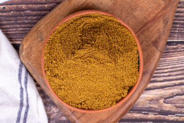 Ground cumin or Jeera Powder. Powder cumin spice in bowl on wooden background. Dry spice concept. Top view