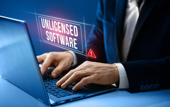 Unlicensed software concept. Businessman gets warning about unlicensed software on his computer