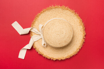 Straw hat on color background, top view