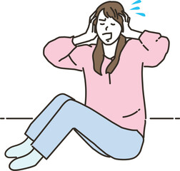 頭を抱える若いアジア人女性
