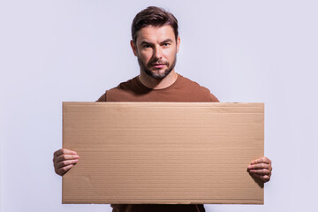 Man with empty blank board on studio background. Blank signboard with copy space. Advertisement...