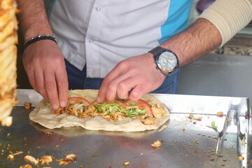 Obraz na płótnie Canvas Konya, Turkey - May 30, 2023: Chef preparing and making Traditional Turkish Doner Kebab meat. Shawarma or gyros, fast food in Konya.