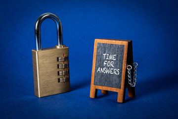 Time for Answers Concept. Miniature chalk board and padlock on a blue background