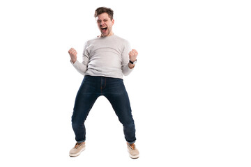 Happy winner. Full length portrait of happy young handsome man gesturing and keeping mouth open...