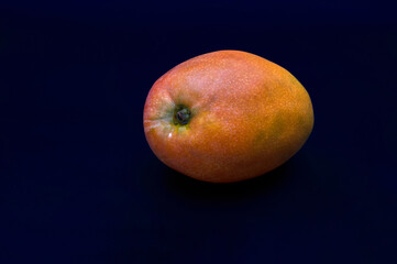 Fototapeta na wymiar Ripe mango fruit on black background