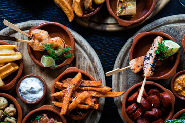 Tapas Bowls with Food arranged on a Table in a Tapas Bar.