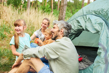 Parents and children spending leisure time in forest