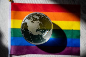 Crystal globe on a rainbow flag. LGBT community.