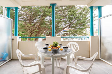 Breakfast on a terrace on a summer morning, healthy breakfast on a terrace of a summer house