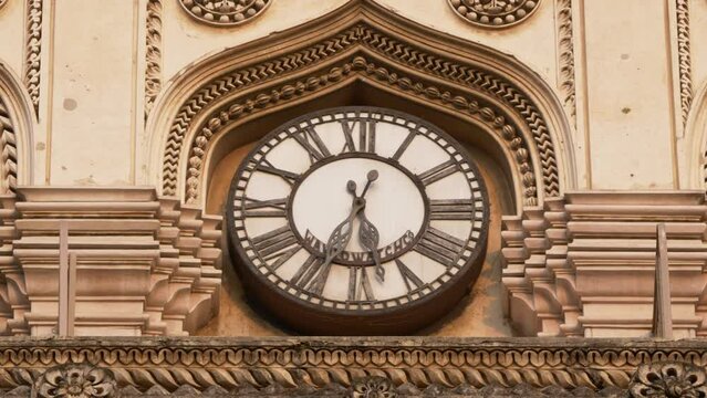 Close-up shot of the famous clock on the four cardinal directions at historical Charminar, Hyderabad, India