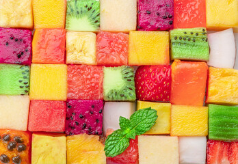 Fruit puzzle. Colorful food background or pattern arranged of different fruit cubes. Dietary...