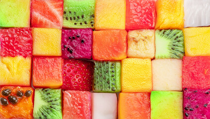 Fruit puzzle. Colorful food background or pattern arranged of different fruit cubes. Dietary concept.