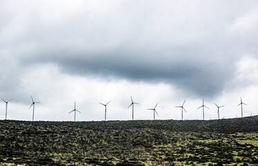 wind turbines in the field in stormy weather with dark clouds