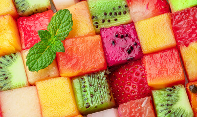 Fruit puzzle. Colorful food background or pattern arranged of different fruit cubes. Dietary...