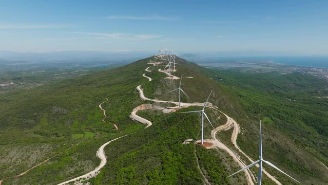 Montenegro, wind turbines on the ridge in mountains, summer sunny day. Aerial view