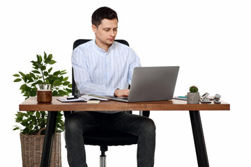 young man using laptop computer for online work at table