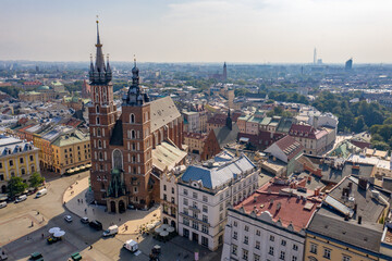 Fototapeta na wymiar Saint Mary's Basilica in Kraków (Kościół Mariacki), Poland - Brick Gothic church on the Main Market Square - drone aerial photo on sunny day
