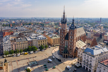 Fototapeta na wymiar Saint Mary's Basilica in Kraków (Kościół Mariacki), Poland - Brick Gothic church on the Main Market Square - drone aerial photo on sunny day