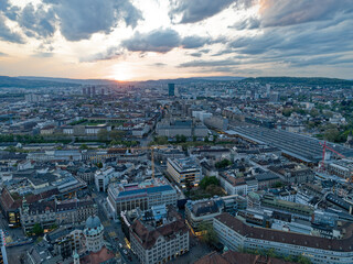 Fototapeta na wymiar Aerial view over Swiss City of Zürich with skyline and Limmat Valley in the background on a beautiful spring evening with colorful dramatic sky. Photo taken May 6th, 2023, Zurich, Switzerland.