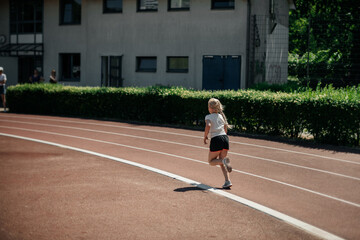 Fototapeta premium The girl runs a school marathon, the concept of a healthy lifestyle.