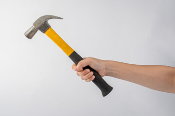 Hand with hammer on white background.