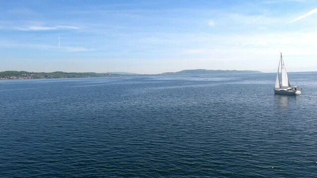 Lake Constance on a German flag excursion boat and blue water with sailing boats