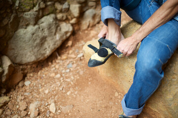 Climber putting on his climbing shoes in the Mallos de Riglos in Spain.