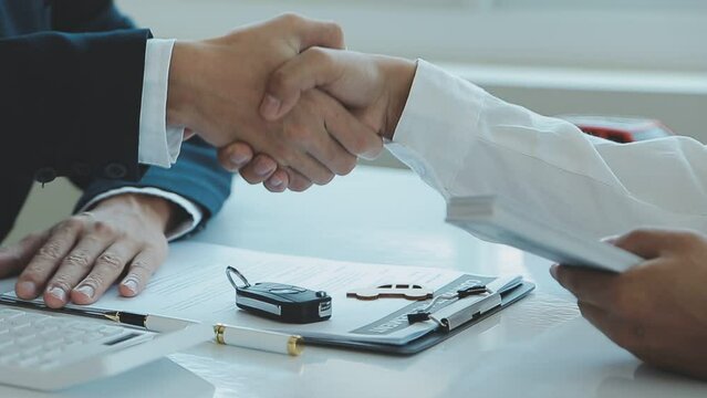 Car salesman gave the keys to the customers who signed the purchase contract legally, Successful completion of car sales, Purchase contract and key delivery.