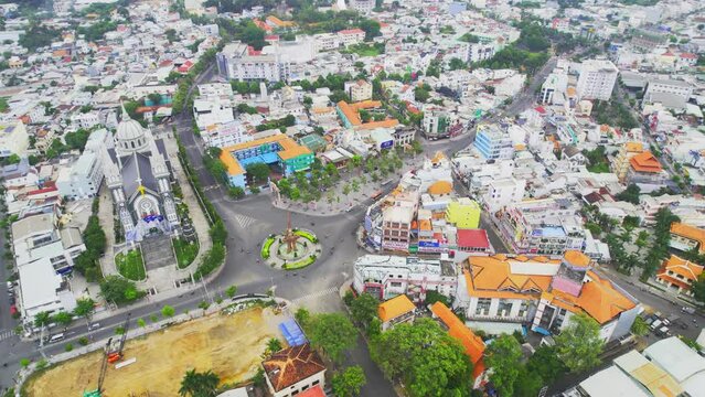 Aerial view of Thu Dau Mot cityscape at morning with church on hill in center. Urban development texture, transport infrastructure and green parks along Be River in Southeast region of Vietnam