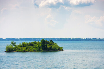 island on strbske pleso water reserve. tranquil nature background. calm summer weather