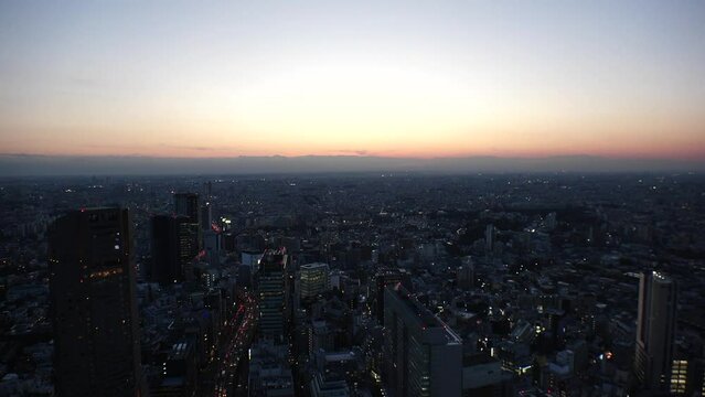 TOKYO, JAPAN : Aerial high angle sunset or sunrise CITYSCAPE of TOKYO. View of buildings around Shibuya. Japanese city life and nature concept. Colorful gradation sky. Real time shot.