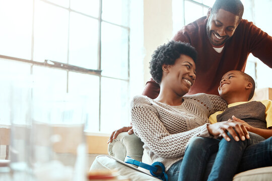 Happy, Love And Family Bonding On A Sofa Together In The Living Room Of Their Modern House. Happiness, Smile And African Parents Spending Quality Time, Talking And Relaxing With Her Boy Child At Home