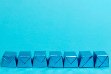 Chocolate candy in a blue wrapper on blue background