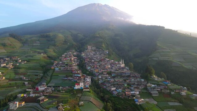 Drone shot : Amazing view of duplicate of Namche Bazaar in Indonesia. Dusun Butuh or Nepal Van Java on the slope of Mount Sumbing. Terraced colorful house. Mount Sumbing climbing post - 4K aerial view