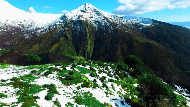 Landscapes in the green mountains with snow peak in sunny day with blue sky Tikejda Algeria