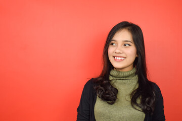 Smiling and Looking Away Of Beautiful Asian Woman Isolated On Red Background