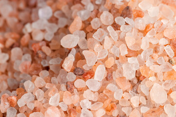 Fototapeta na wymiar A large number of pink salt crystals of different sizes