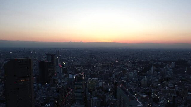 TOKYO, JAPAN : Aerial high angle sunset view of CITYSCAPE of TOKYO. Buildings and street around Shibuya station. Japanese urban city life, metropolis and travel concept. Time lapse shot, dusk to night