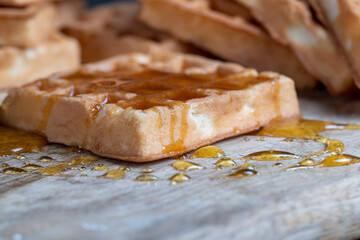 Soft fresh waffles with bee honey close-up