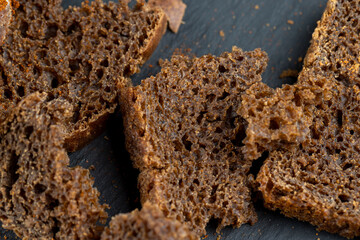 pieces of black rye bread from mixed wheat flour with rye flour