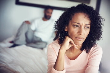 Angry, sad and couple in bedroom for problem, divorce decision and marriage fail or mental health risk. Depression, fight and african woman thinking with partner at home depressed, anxiety or stress