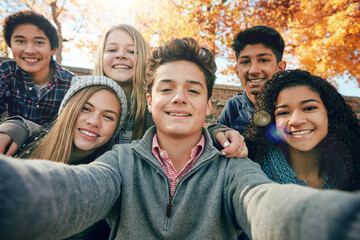Teenager, group of friends and selfie in park, nature or fall trees and teens smile, picture of friendship and happiness for social media. Portrait, face and diverse people together for autumn photo - Powered by Adobe